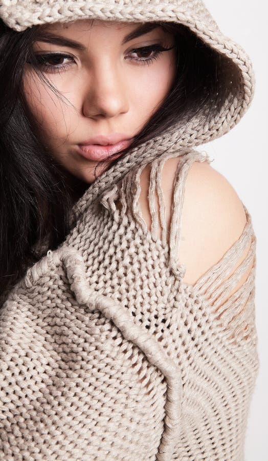 Beautiful young brunette in a woollen sweater