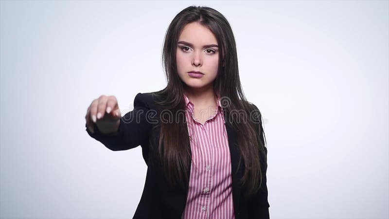 Beautiful young business woman holding and throwing money