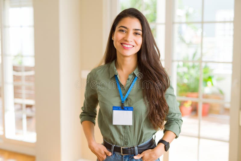 Beautiful young business woman wearing id card