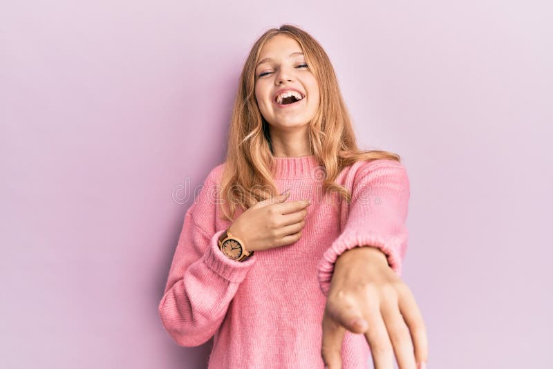 Beautiful young caucasian girl wearing casual clothes laughing at you, pointing finger to the camera with hand over body, shame