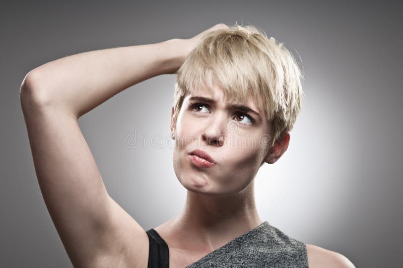 Beautiful Young Caucasian Woman Scratching Her Head royalty free stock photo Beautiful Young Caucasian Woman Scratching Her Head royalty free stock photo