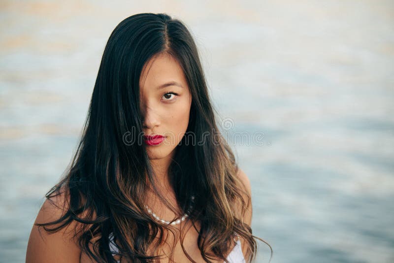 Portrait of good looking sexy Chinese woman with long black hair