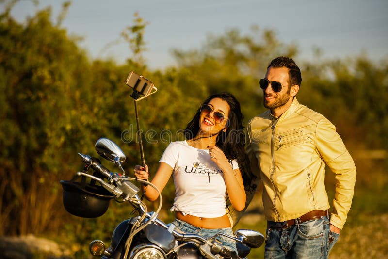 Beautiful Young Couple with a Motorcycle Stock Photo - Image of meadow ...