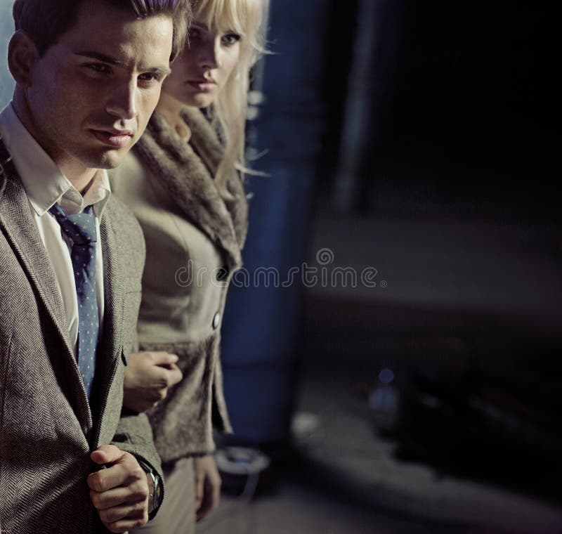 Beautiful young couple walking together in night city stock images Beautiful young couple walking together in night city stock images
