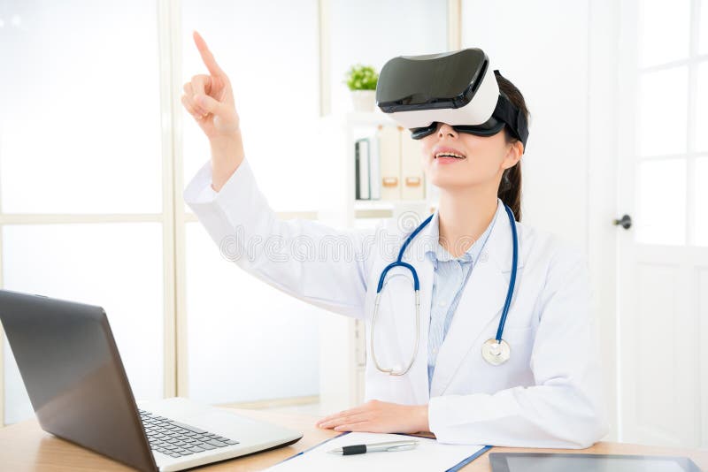 Beautiful doctor woman wearing virtual reality