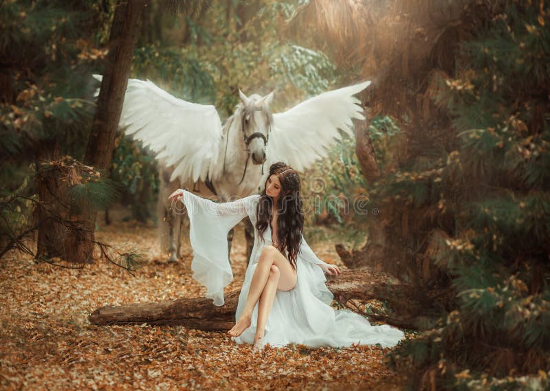 Beautiful, young elf, walking with a unicorn. She is wearing an incredible light, white dress. Artistic Photo