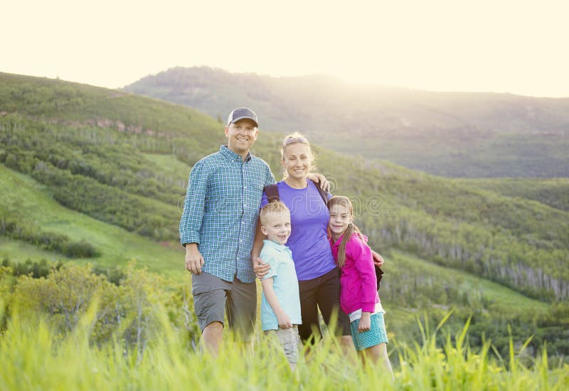 A beautiful young family hiking on a nice scenic evening in the rocky mountains of Utah in the United States of America. A beautiful young family hiking on a nice scenic evening in the rocky mountains of Utah in the United States of America