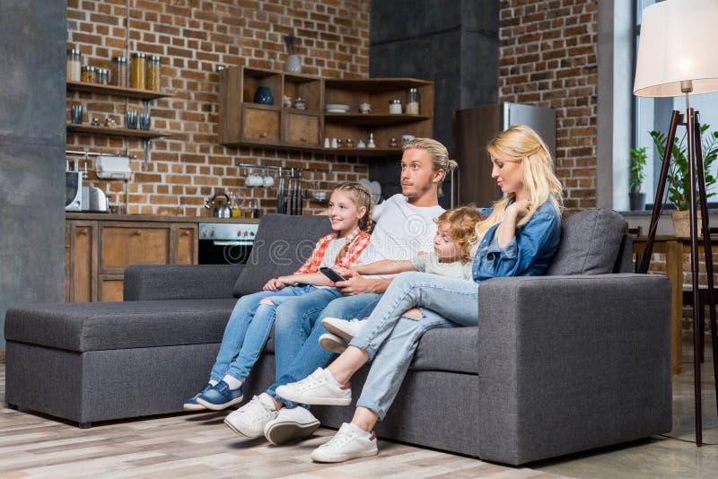 beautiful young family with two kids watching tv royalty free stock photo beautiful young family with two kids watching tv royalty free stock photo