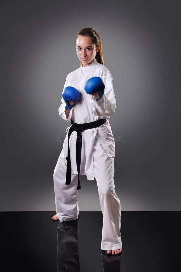 Group of Beautiful Young Female Karate Players Celebrating on the Gray Background Stock Photo