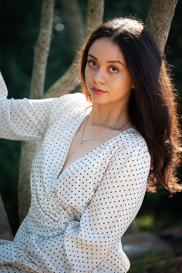 Beautiful Young Female in a Sundress Posing Near Trees in Majik Forest Beautiful Young Female in a Sundress Posing Near Trees in Majik Forest