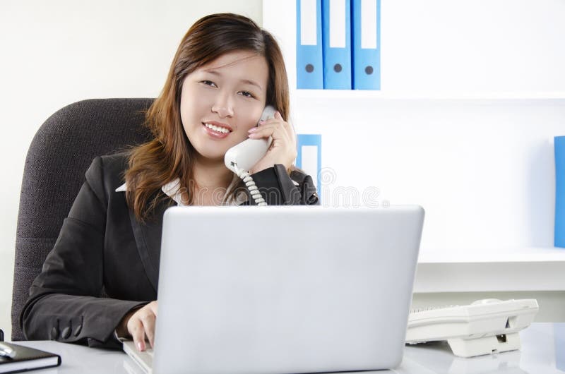 Beautiful young female working in office stock photos