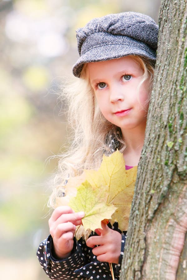 Beautiful young girl with autumn leaves