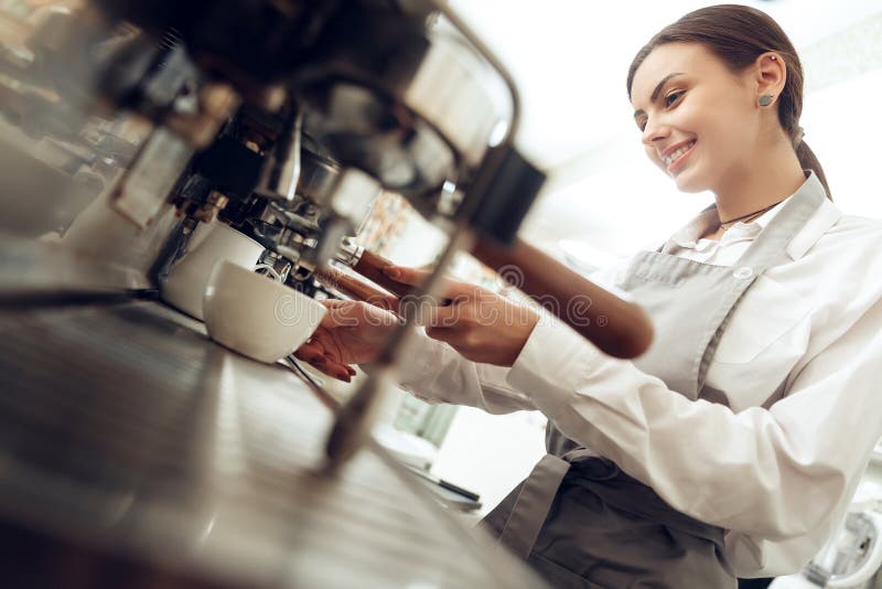 Beautiful young girl barista preparing coffee stock image Beautiful young girl barista preparing coffee stock image