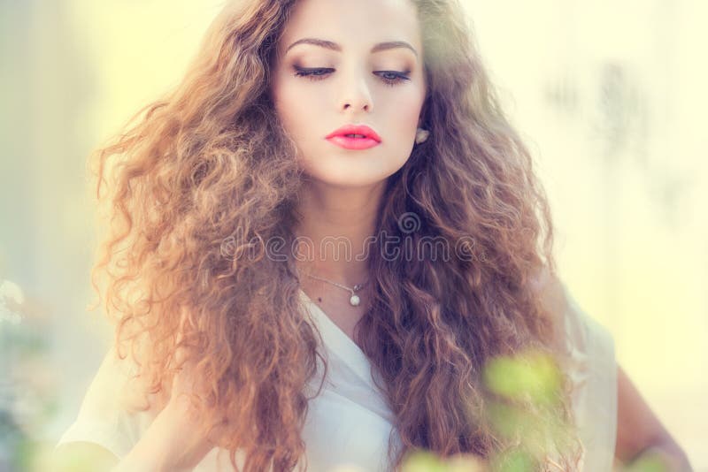 Beautiful young girl with curly hair