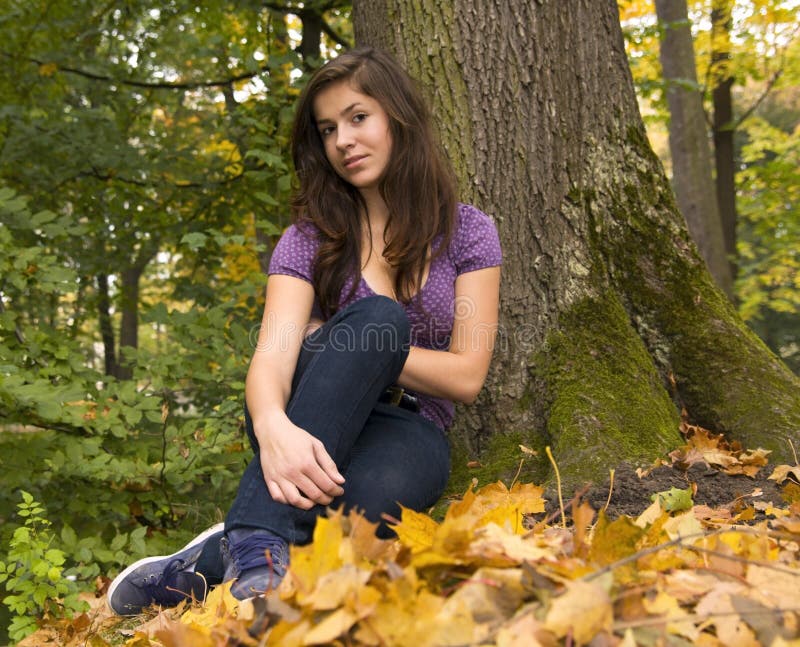 Beautiful young girl with dark hair in the park 4