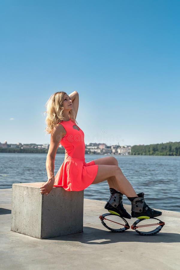 Premium Photo  Female trainer doing exercises jumping in the kangoo jumps  boots outdoor fitness workout lifestyle