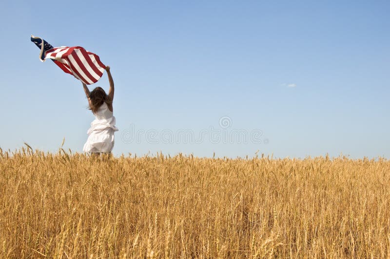 Beautiful young girl holding an American flag