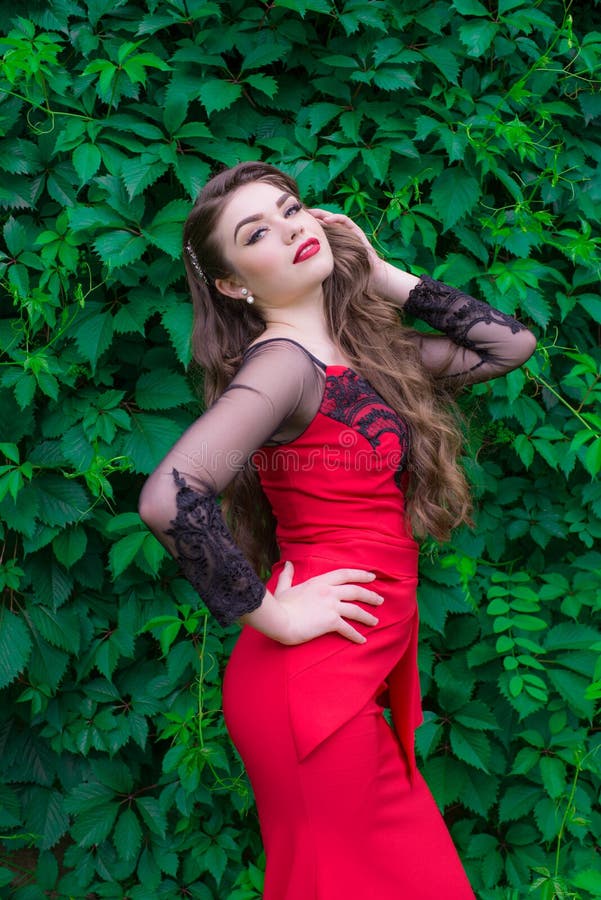 Beautiful Young Girl with Long Hair in an Evening Fashionable Red Dress ...