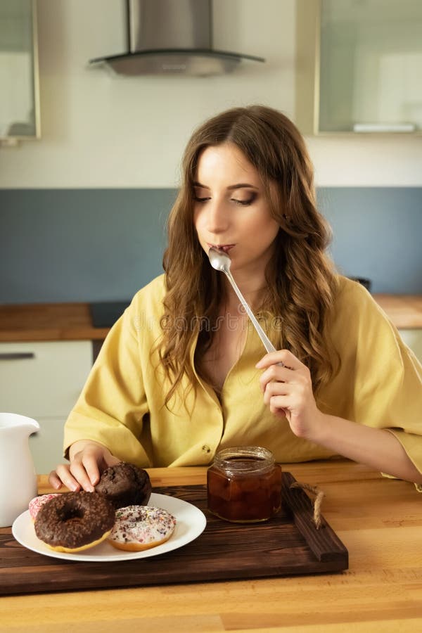 Young beautiful girl having breakfast at home in the kitchen. royalty free stock photo Young beautiful girl having breakfast at home in the kitchen. royalty free stock photo