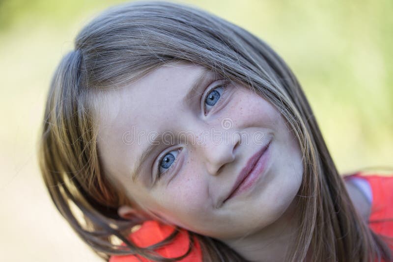 Beautiful young girl outdoors, portrait children close up