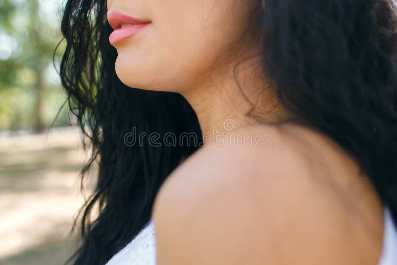 Beautiful young girl with red lips. Part of the female face with red lips. Close-up of woman`s lips with glossy red lipstick