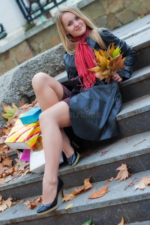 The beautiful young girl with a shopping bags