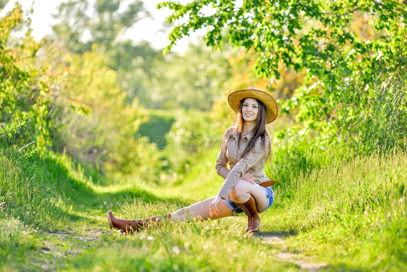 Beautiful Young Girl is Sitting on the Grass in the Garden Stock Photo ...