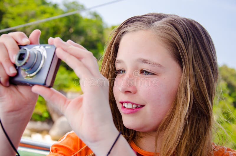 Beautiful Young Girl Taking Photos With A Digital Camera Stock Image
