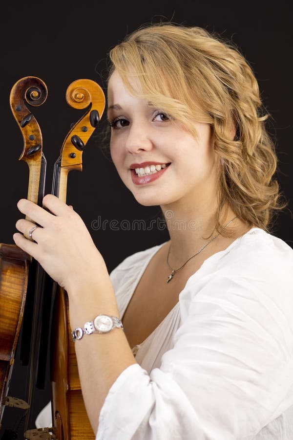 Beautiful young girl with violin and viola stock image