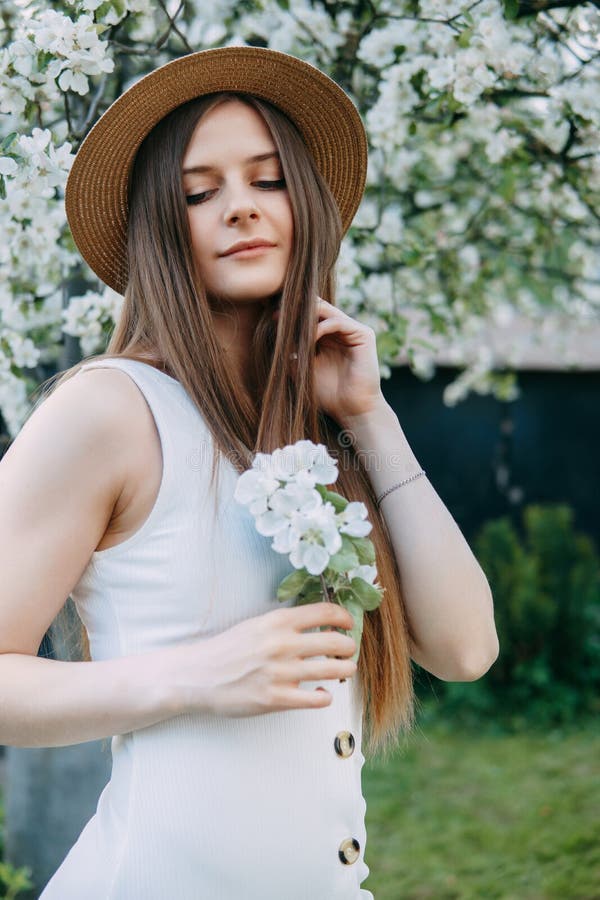 Beautiful Young Girl in White Dress and Hat in Blooming Apple Orchard ...