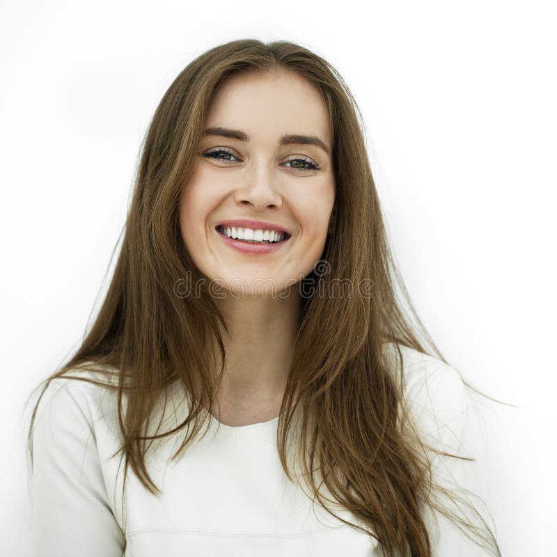 Beautiful young happy woman posing against a white wall