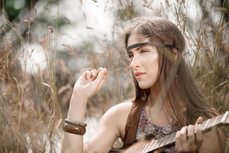 Beautiful young hippie girl has a rest on the nature.