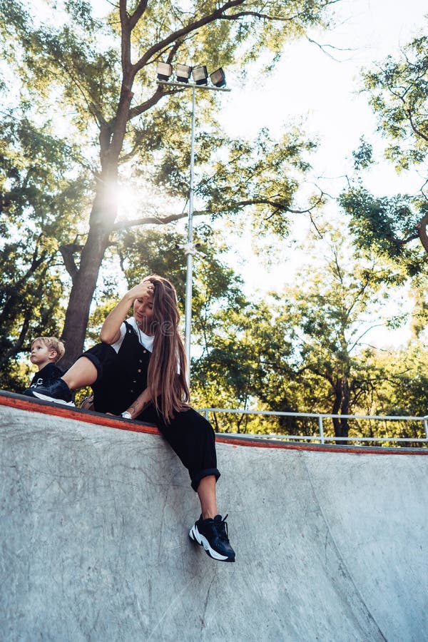 Beautiful Young Hipster Girl Sitting on the Edge of a Ramp Stock Photo ...