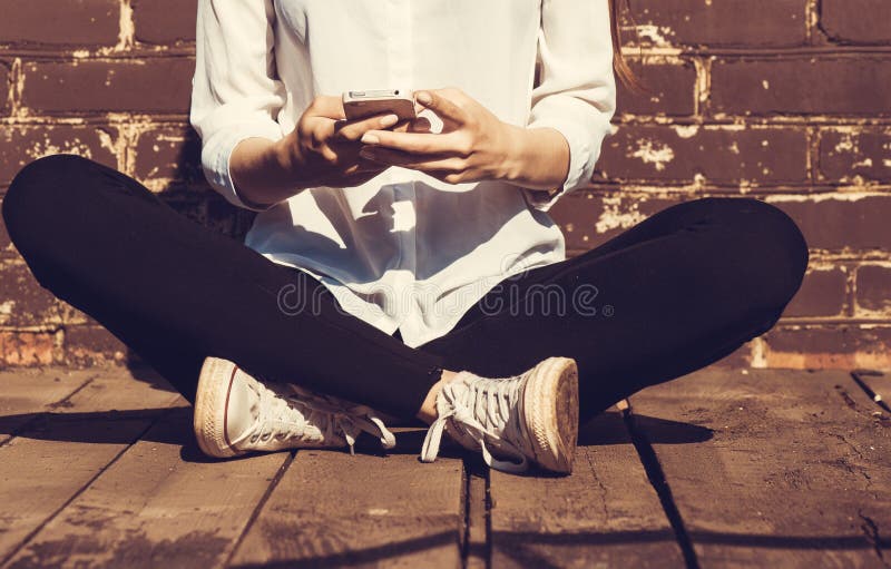 Beautiful young hipster woman using smart phone