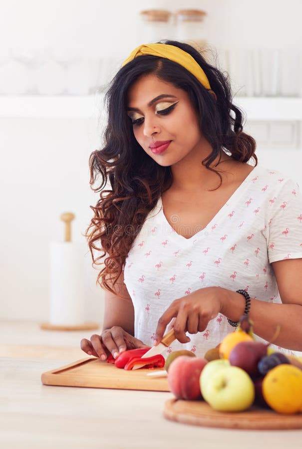 Beautiful young indian woman cutting vegetables on the kitchen, healthy eating stock image Beautiful young indian woman cutting vegetables on the kitchen, healthy eating stock image
