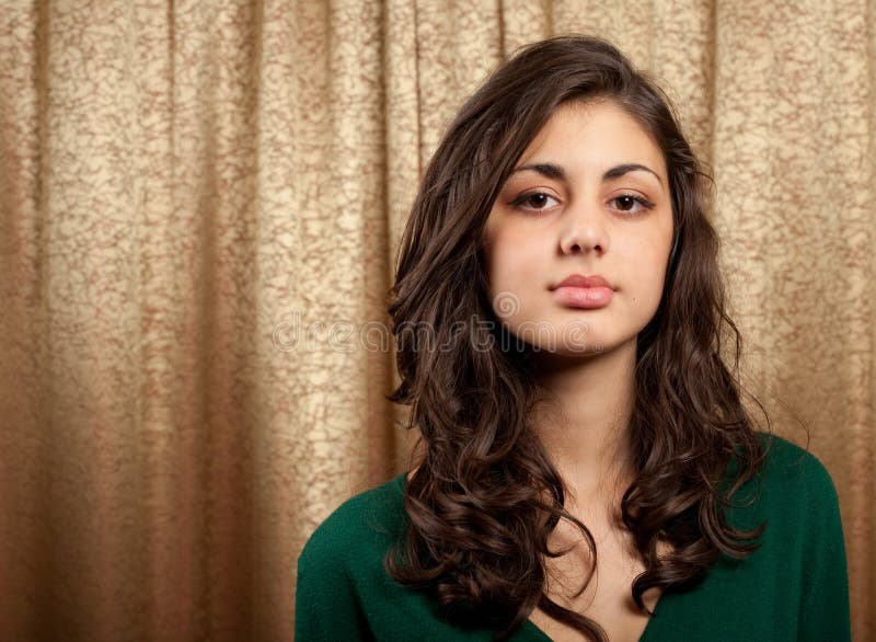 Beautiful young lady on golden curtain background stock photo Beautiful young lady on golden curtain background stock photo