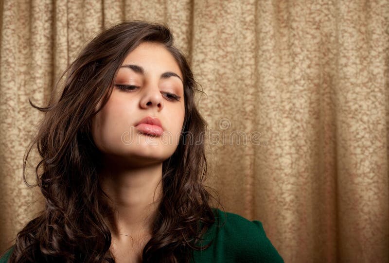 Beautiful young lady on golden curtain background stock photography Beautiful young lady on golden curtain background stock photography
