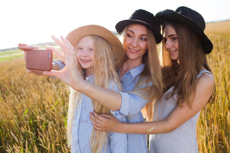 Beautiful young mother and her daughters at the wheat field royalty free stock photos Beautiful young mother and her daughters at the wheat field royalty free stock photos