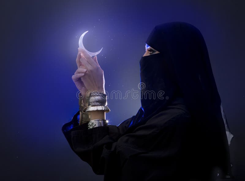 Beautiful young muslim girl holding a moon symbol, spirituality