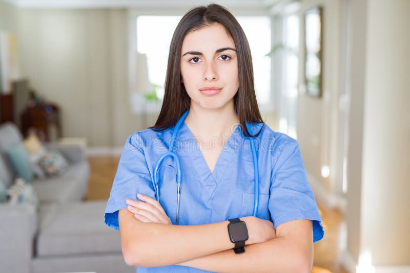 Beautiful young nurse woman wearing uniform and stethoscope at the clinic skeptic and nervous, disapproving expression on face