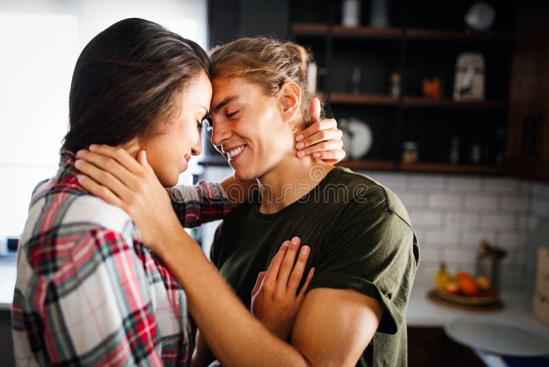 Beautiful Young Passionate Couple is Smiling and Hugging before Having Sex at Home Stock Photo