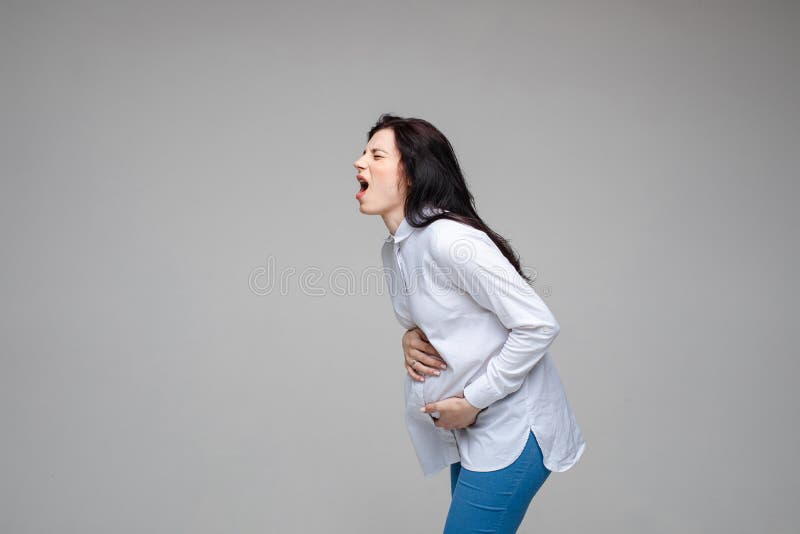 beautiful young pregnant woman screaming beacuse of a strong stomach ache