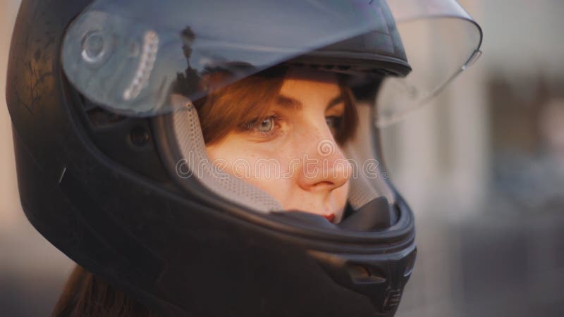 Beautiful young red-haired woman motorcyclist with black motorcycle helmet royalty free stock photos Beautiful young red-haired woman motorcyclist with black motorcycle helmet royalty free stock photos