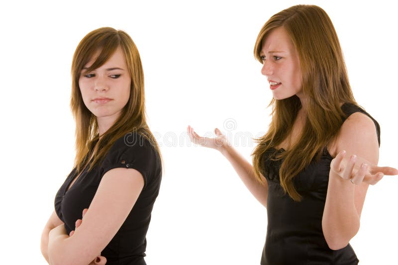 Beautiful young sisters indicating and arguing, isolated on white. Beautiful young sisters indicating and arguing, isolated on white.