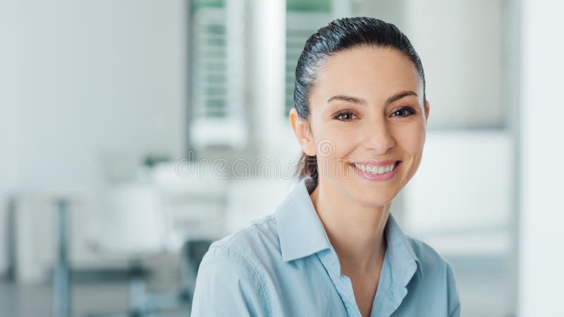 Beautiful smiling business woman posing in the office