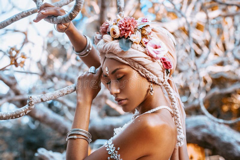 Beautiful young stylish woman wearing flowers wreath outdoors portrait