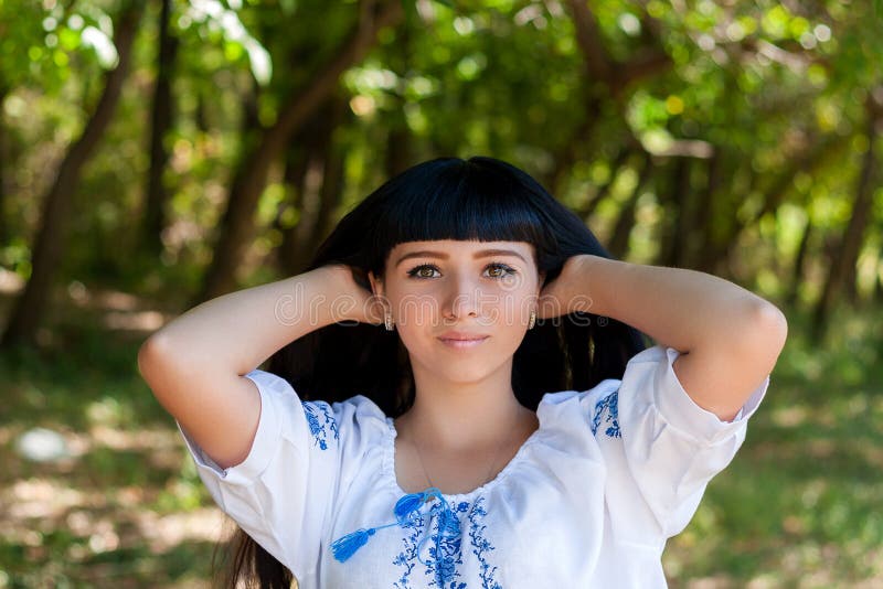 Beautiful young Ukrainian girl in national costume. Girl with beautiful appearance in the woods on the nature. Portrait of beautif royalty free stock image Beautiful young Ukrainian girl in national costume. Girl with beautiful appearance in the woods on the nature. Portrait of beautif royalty free stock image