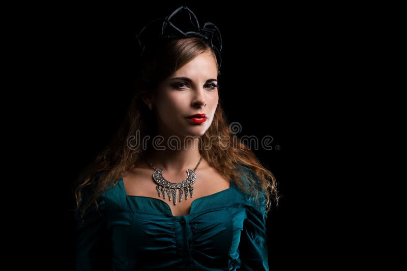 Beautiful young witch in a black crown