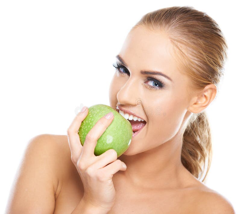 Beautiful young woman bites a green apple stock image Beautiful young woman bites a green apple stock image