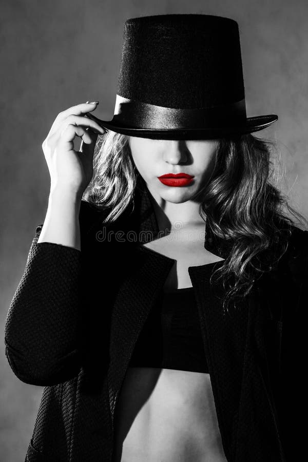 Beautiful young woman in a black hat and a black jacket. Bright red hat stock images, royalty-free photos and pictures